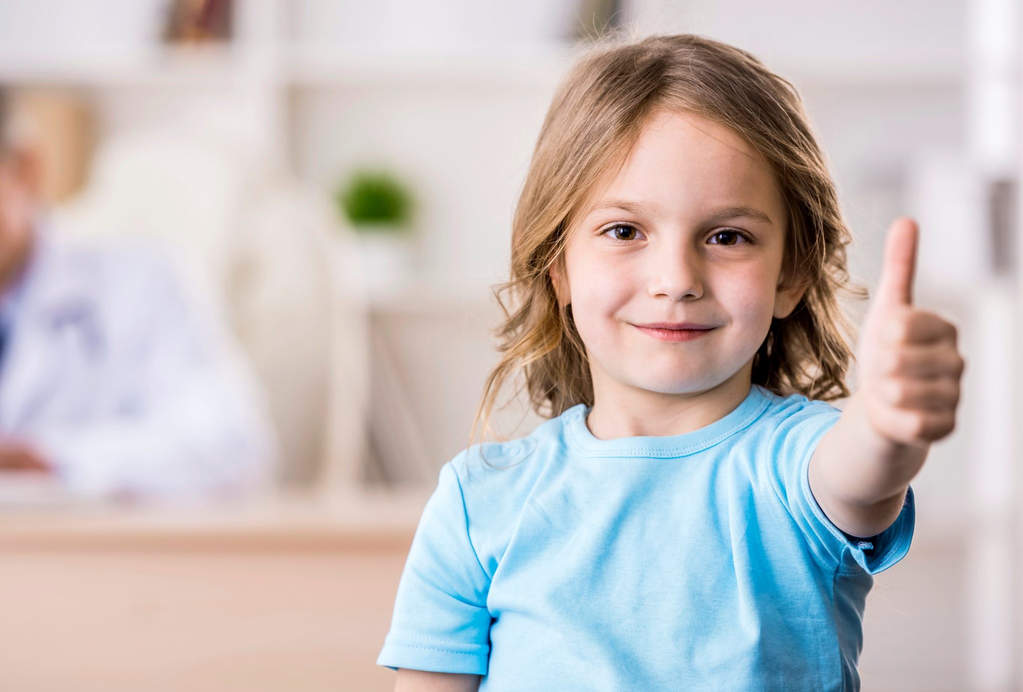 Child giving thumbs up