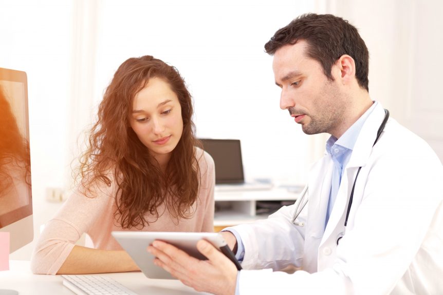 Doctor using tablet to inform patient
