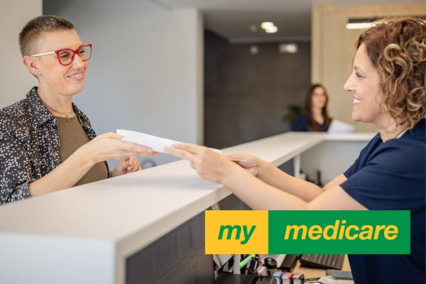 Photo of a medical receptionist and patient